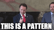 a man in a suit and tie is giving a speech with the words " this is a pattern " below him