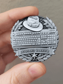 person holding a coin that says keyboard warrior