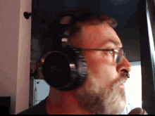 a man with a beard wearing headphones and a nose ring