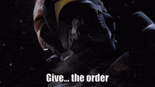 a man in a mask is holding a robotic hand that says `` give the order '' .