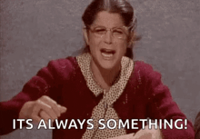 a woman wearing glasses and a red sweater is saying `` it 's always something '' .