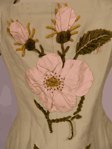 a close up of a flower embroidered on a white cloth