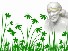 a statue of sai baba is surrounded by green flowers and grass .