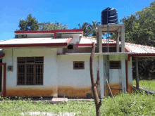 a house with a blue water tank on the roof