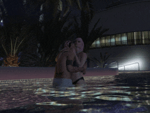 a man and woman are kissing in a swimming pool