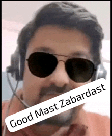 a man wearing sunglasses and headphones with the words good mast zabardast on the bottom