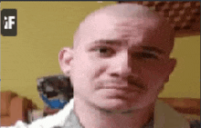 a pixelated image of a man 's face with the letter f visible