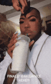 a woman drinking a milkshake with the words finally @akilaface here