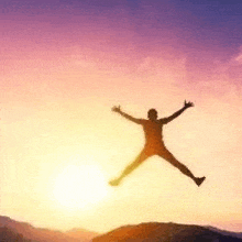 a man is jumping in the air at sunset .