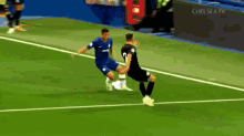 two soccer players on a field with the words chelsea tv in the corner