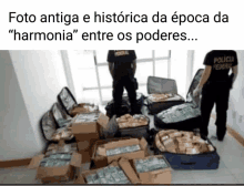 two federal officers are standing in front of a pile of money and boxes