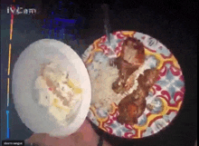 a person is holding a plate of food next to a plate of rice and meat ..