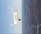 a plane is flying through the air with the word finnair on the side of it .
