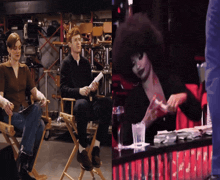 a man and a woman sit in director 's chairs next to a woman with a large afro