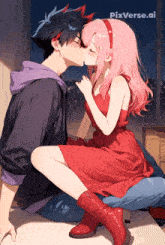 a girl in a red dress is kissing a boy on the cheek