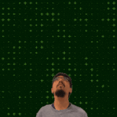 a man stands in front of a green background with the number 15 in the center