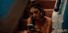 a woman talking on a cell phone with the word bravas on the bottom