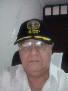 a man wearing a u.s. army veteran hat and glasses