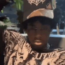 a man wearing a hat and a supreme shirt