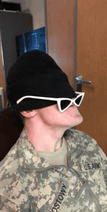 a us army soldier wearing sunglasses and a black hat