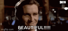 a man in a suit and tie is smiling and says beautiful !!!