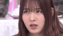 a close up of a young woman 's face with a serious look on her face .