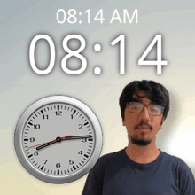 a man stands in front of a clock that says 8:14 am