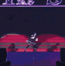 a woman in a maid costume is dancing on the stage