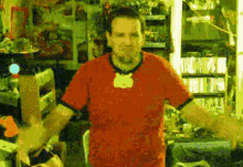 a man in a red shirt is standing in front of a refrigerator