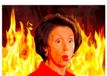 a woman in a red shirt is standing in front of flames