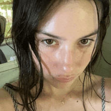 a woman with wet hair looks at the camera