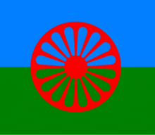 a gypsy flag with a red wheel on it