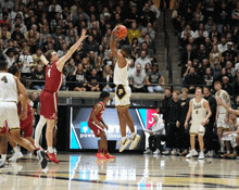 a basketball game is being played in front of a screen that says power innovate