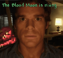 a man 's face is shown with the words the blood moon is rising above it