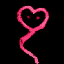 a pink heart with red eyes is being drawn on a black background .