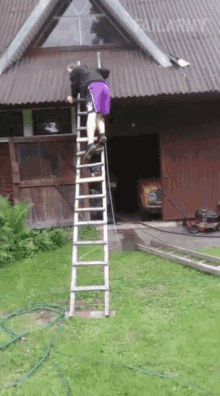 a man is standing on a ladder in front of a building that says " vilary " on the roof