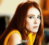 a woman with red hair is wearing a yellow shirt and making a face .