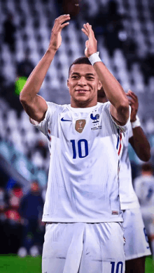 a soccer player wearing a number 10 jersey applauds