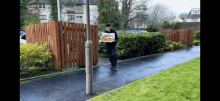 a man is carrying a tray of food on a sidewalk