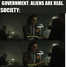 a man is sitting at a table with a lamp and a caption that says government aliens are real society