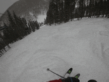 a person is skiing down a snow covered slope