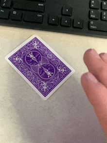 a purple playing card with a bicycle design on it