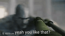 a blurred image of a man holding a gun with the words `` yeah you like that '' written on it .