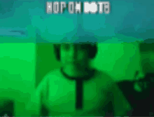 a person wearing headphones and a hat is standing in front of a green background with the word hop on written on it .