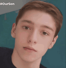 a close up of a young man 's face with #ourson written on the bottom