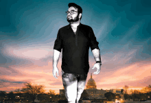 a man standing in front of the capitol building at sunset