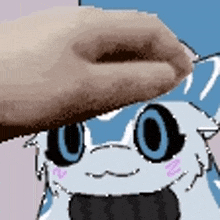 a close up of a person 's hand touching a cartoon character with blue eyes .