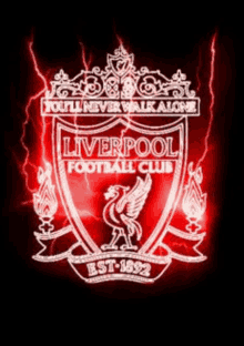 the logo for the liverpool football club is lit up in red