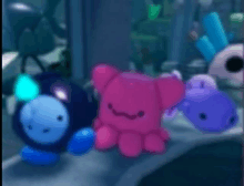 a group of stuffed animals including a pink octopus