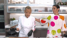 a woman in a polka dot dress is standing next to another woman in a kitchen with the words mesaza en casa above them